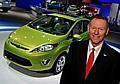 Ford Motor Company, president and CEO, Alan Mulally standing next to a 2011 Fiesta on display at the Washington DC Auto Show.